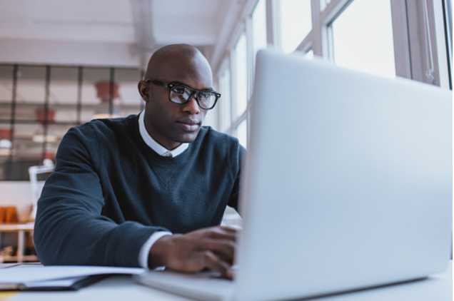 youn African American man on laptop