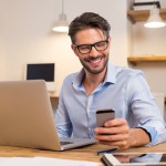 Man working with laptop and smartphone