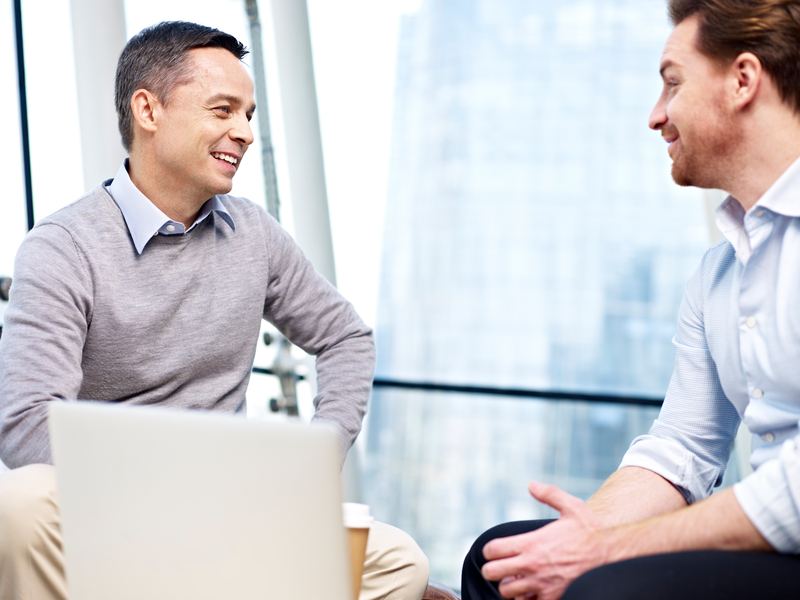 Two men talking in office