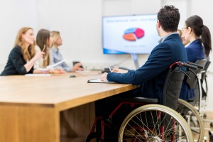 man in wheelchair at business meeting