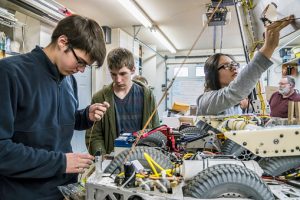 High school students programming a robot