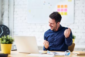 Young man excited at work