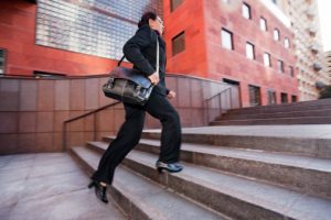 Business woman running up steps