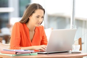 young woman looking at laptop screen