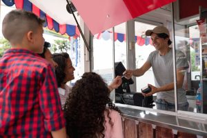 Amusement park cashier selling tickets