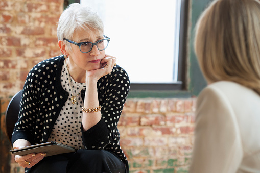 Senior woman listening to a client or patient.