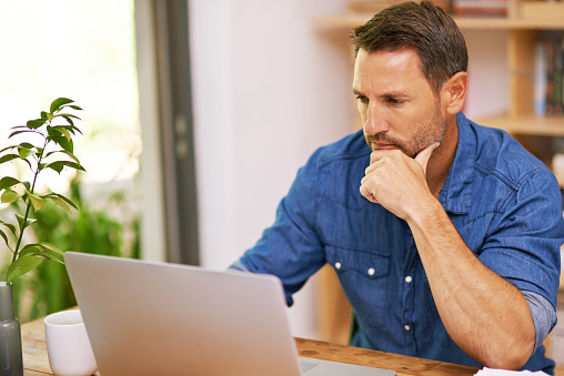 man working on his laptop at home