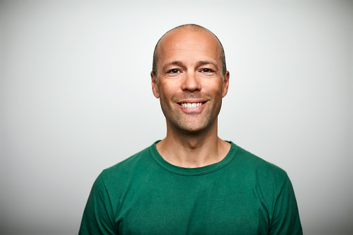 Portrait of mature man smiling on white background