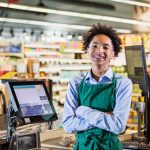 teenage boy working as supermarket cashier